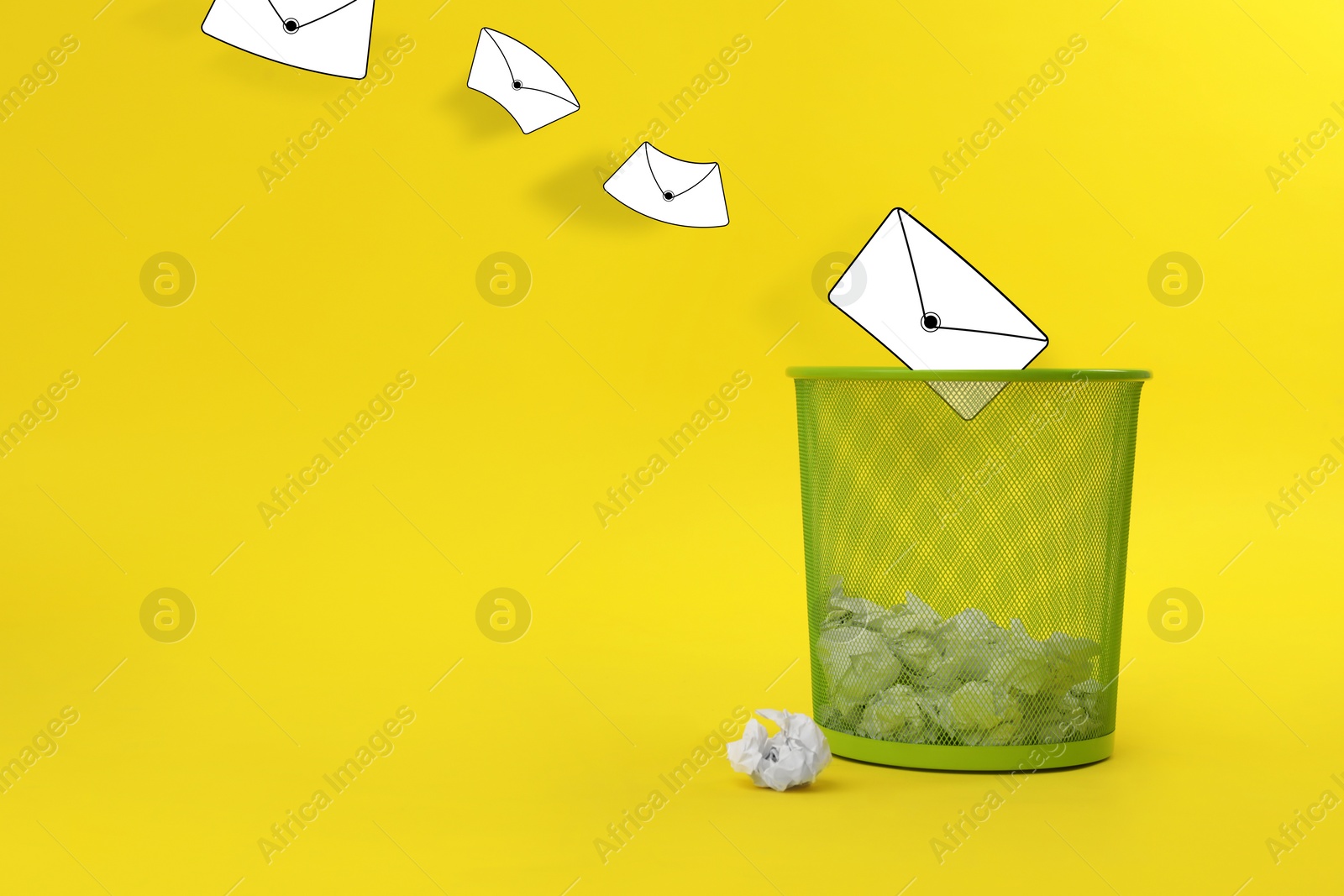 Image of Spam. Drawn envelopes falling into bin with crumpled paper on yellow background