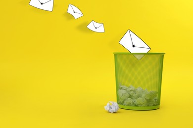 Spam. Drawn envelopes falling into bin with crumpled paper on yellow background