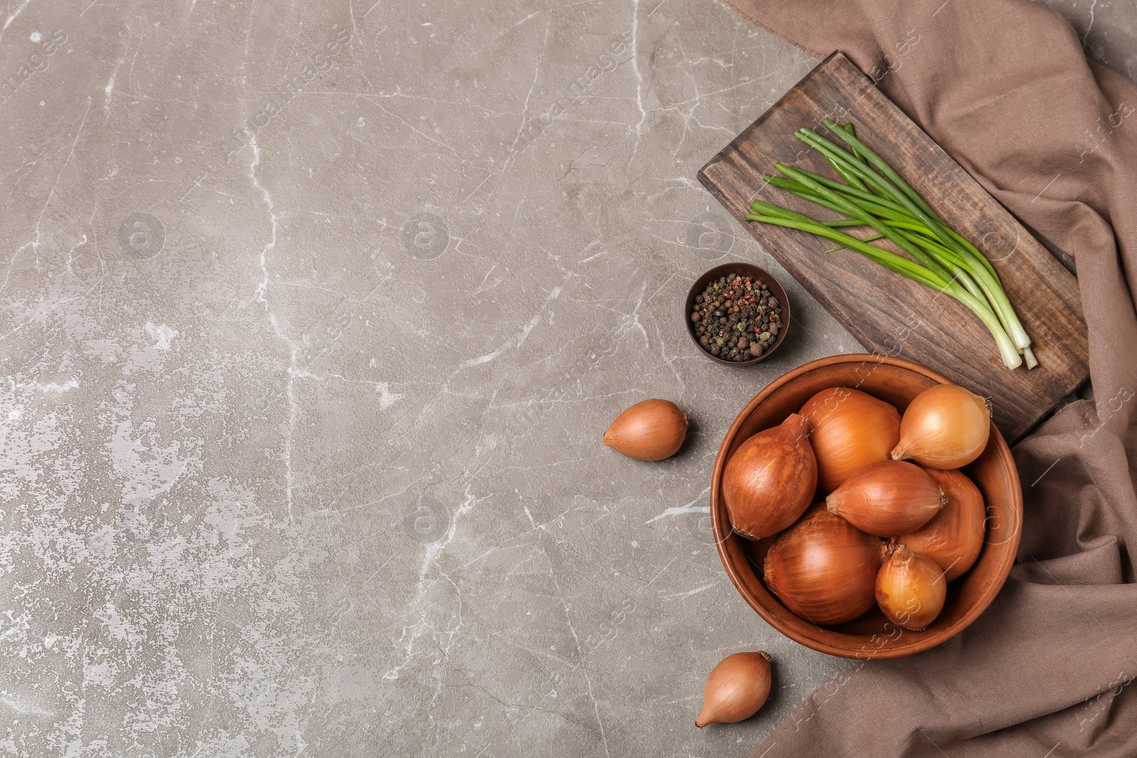 Photo of Flat lay composition with ripe onions on grey background