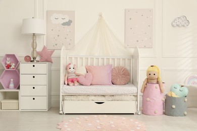 Photo of Cozy baby room interior with crib and toys