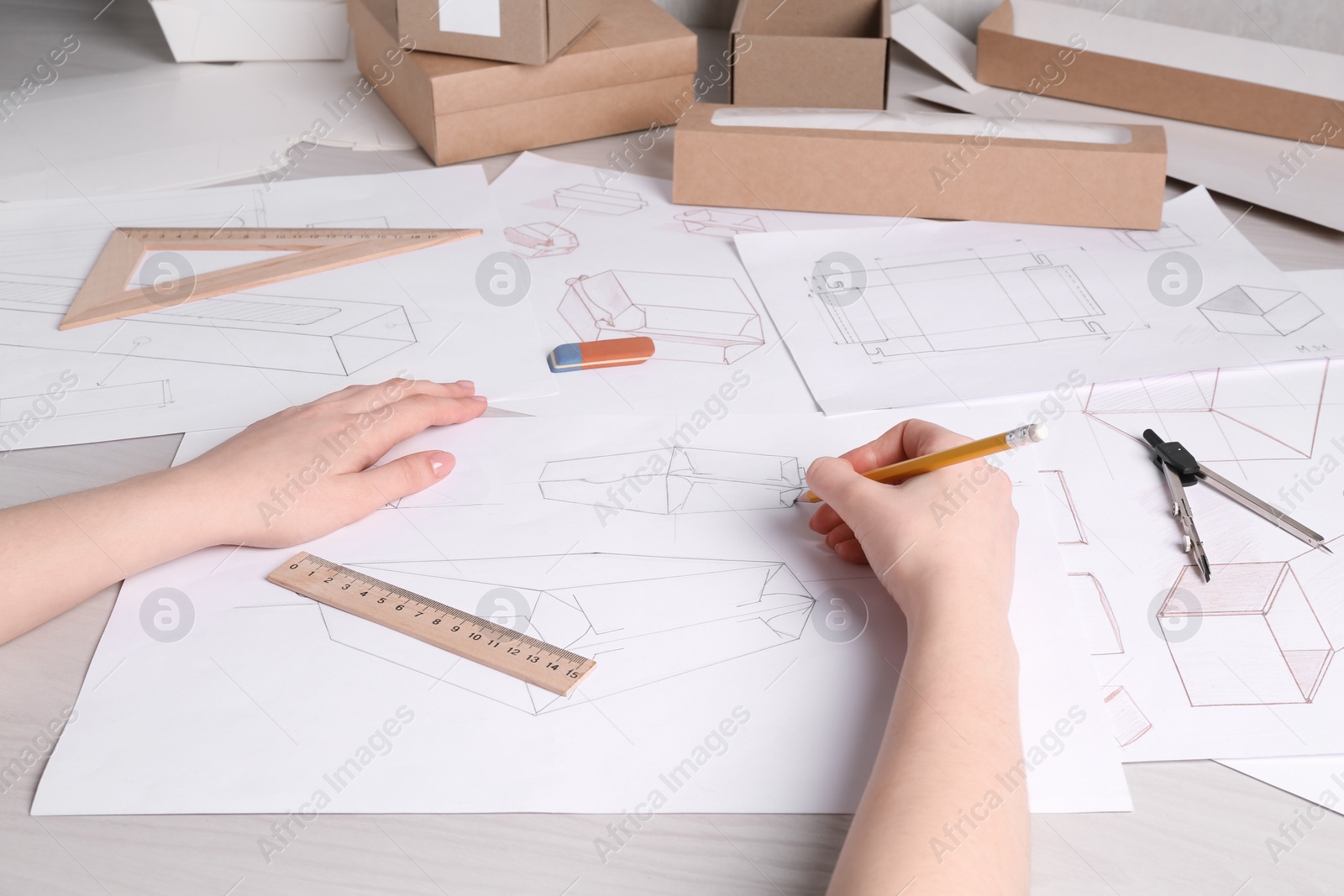 Photo of Woman creating packaging design at table, closeup