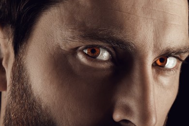 Captivating gaze. Man with brown eyes, closeup