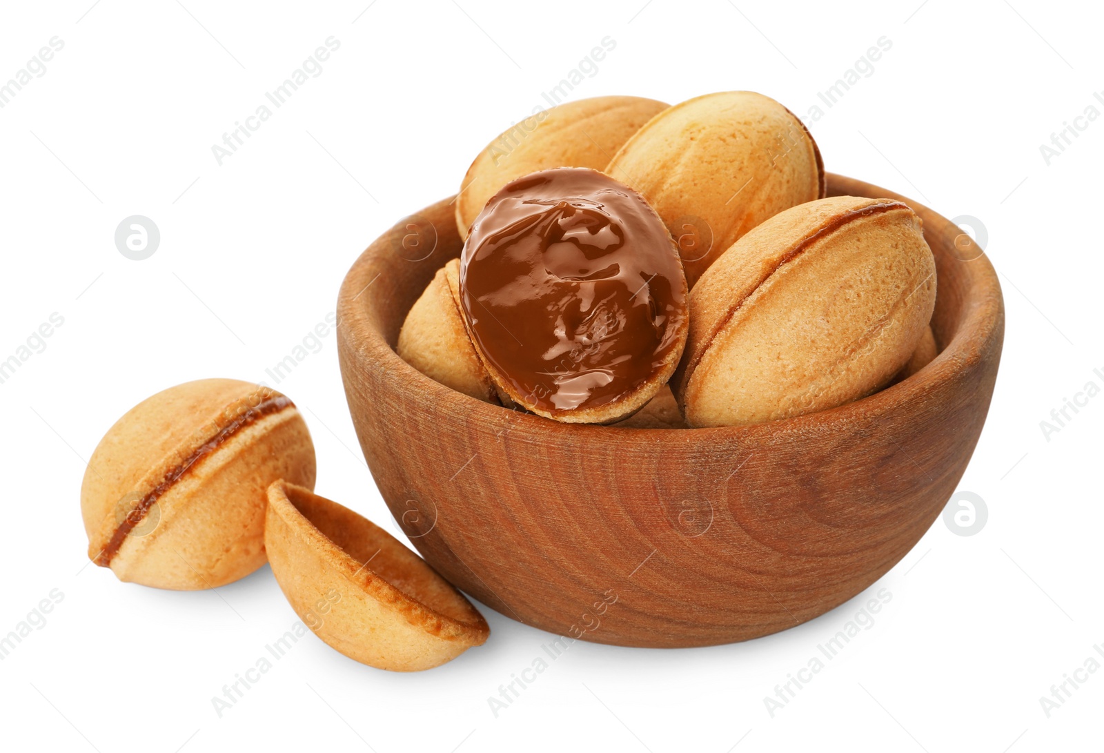 Photo of Delicious nut shaped cookies with boiled condensed milk in wooden bowl on white background