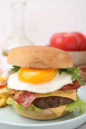 Photo of Delicious burger with fried egg on table, closeup