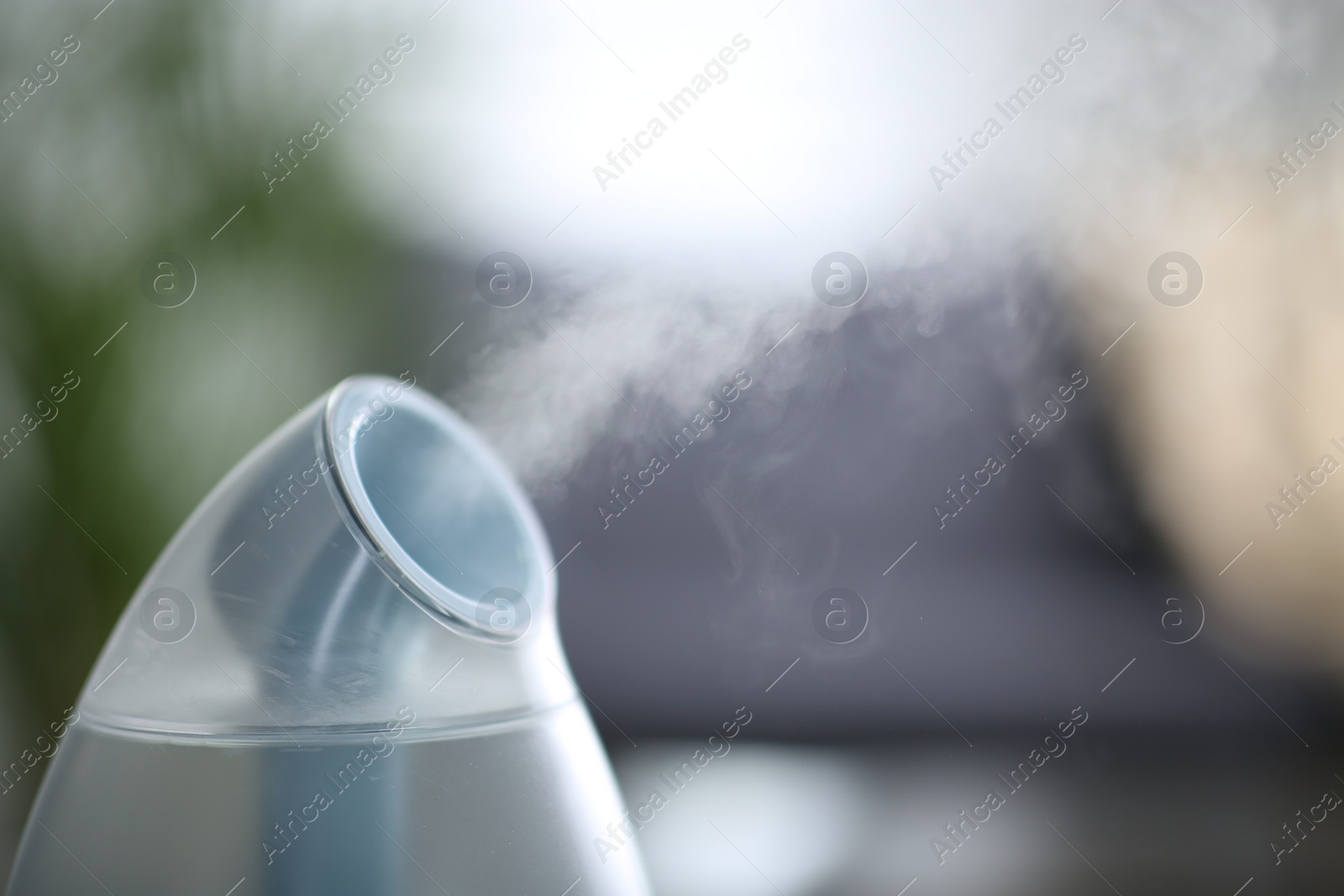 Photo of Modern air humidifier indoors, closeup. Space for text