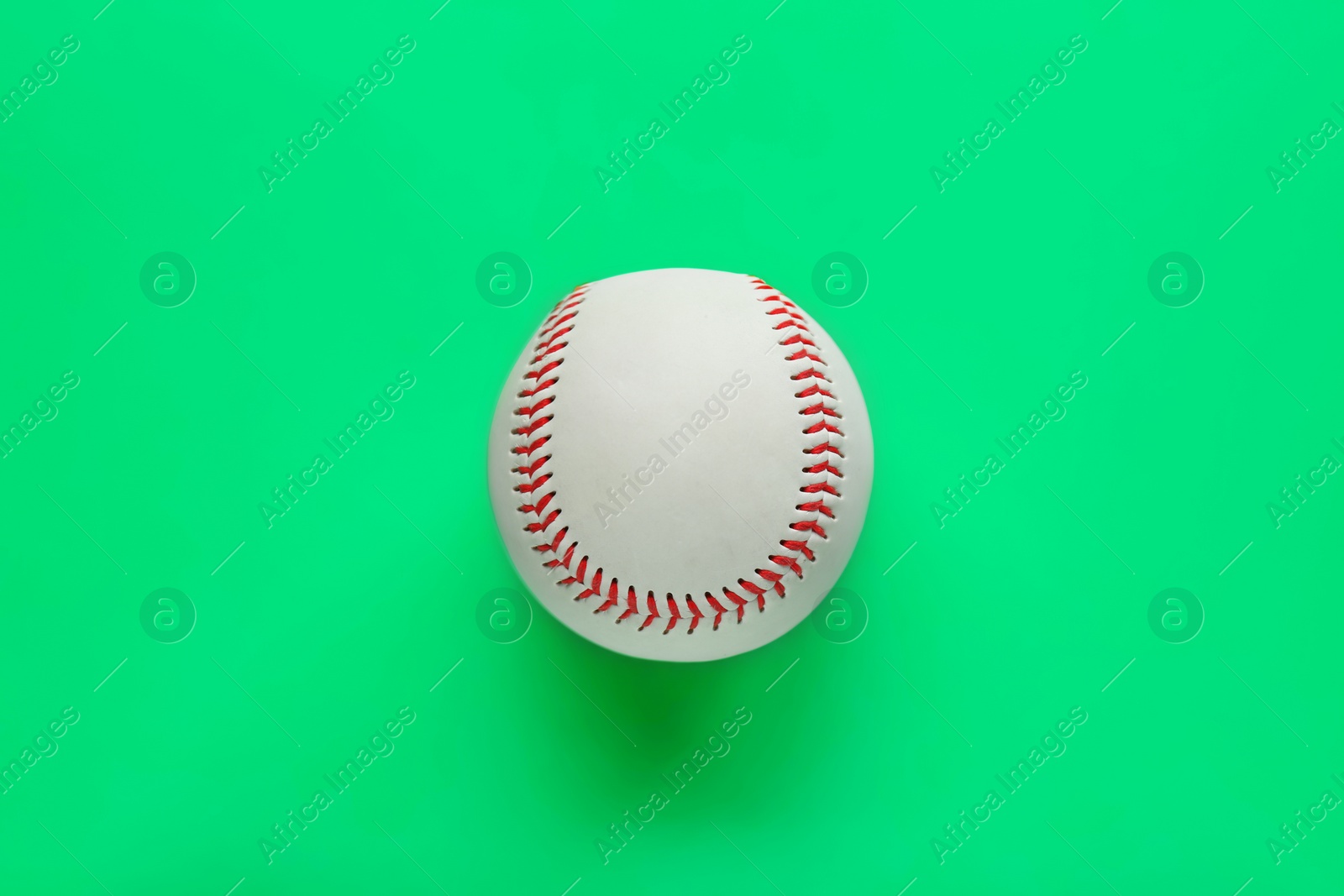 Photo of Baseball ball on green background, top view. Sports game