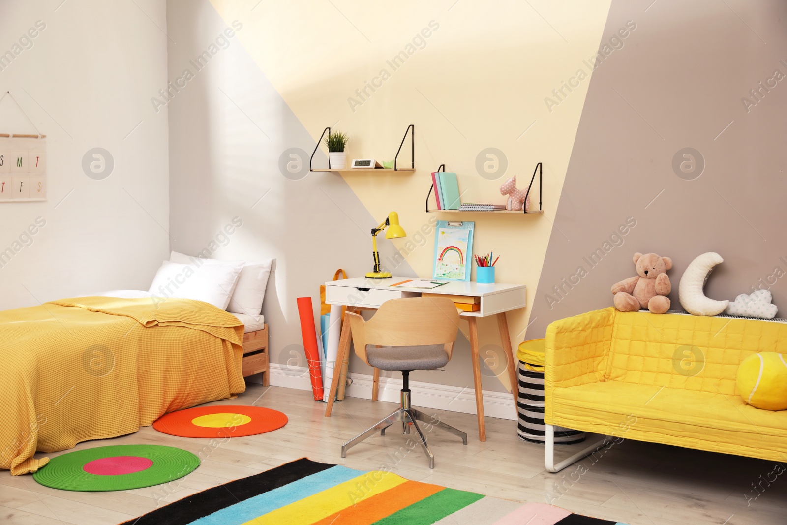 Photo of Stylish child room interior with comfortable bed and desk