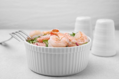 Delicious salad with pomelo, shrimps and tomatoes on white table