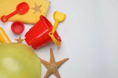Photo of Flat lay composition with beach ball and sand toys on white background