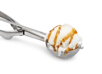 Photo of Steel scoop with tasty caramel ice cream isolated on white