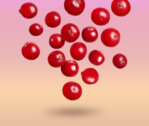 Image of Delicious ripe cranberries falling on color background