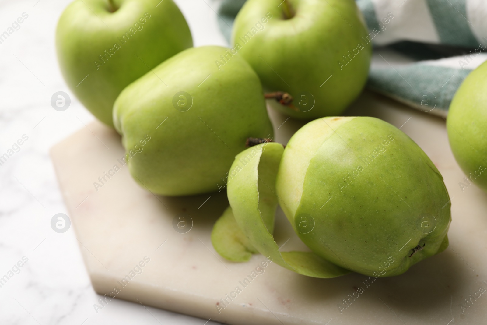 Photo of Ripe green apples on white table, closeup