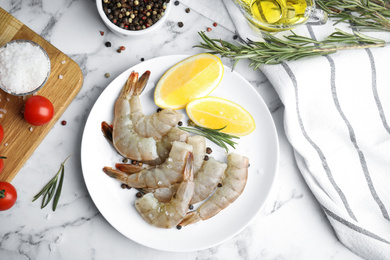 Flat lay composition with fresh raw shrimps on marble table