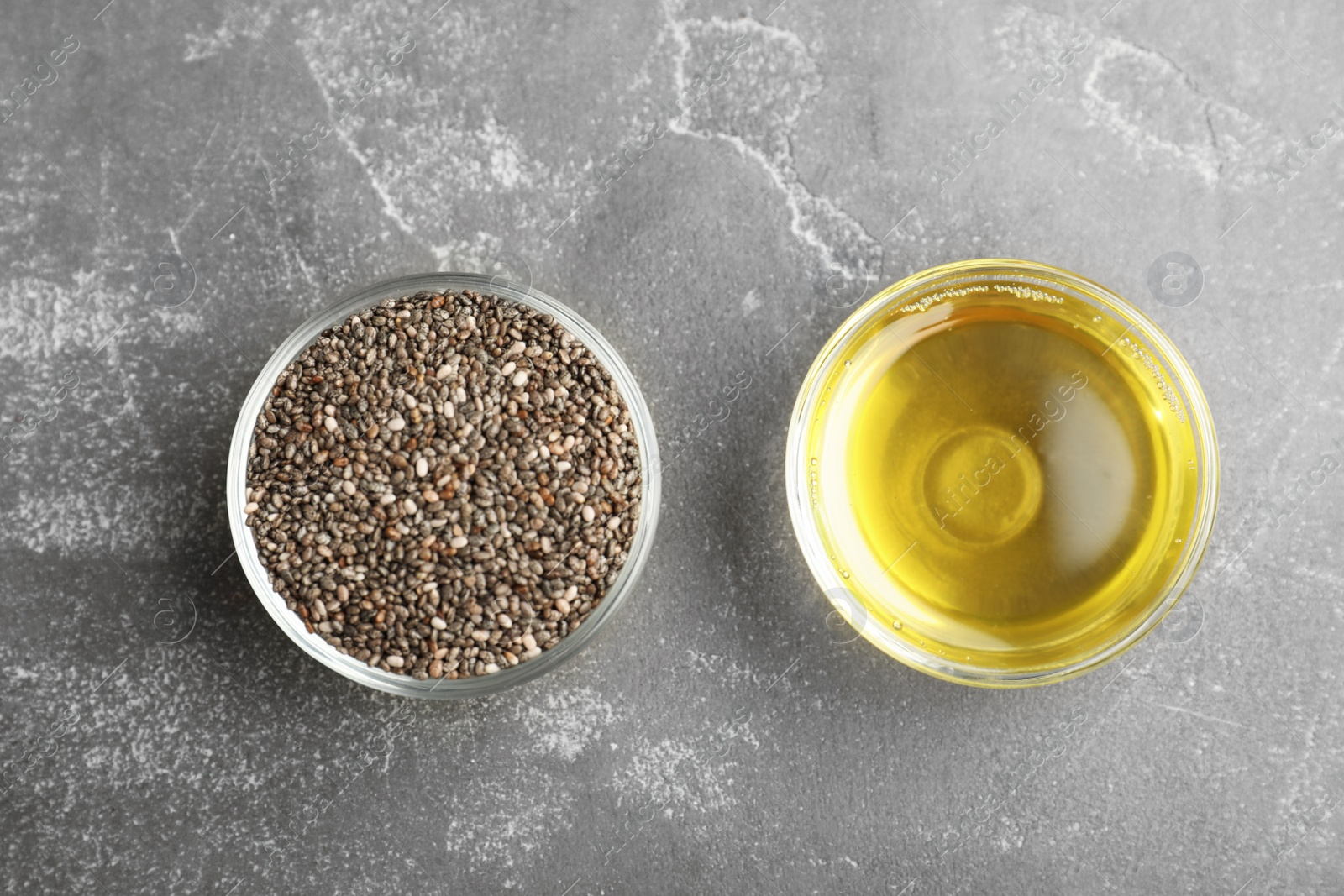 Photo of Flat lay composition with chia seeds and oil on grey table