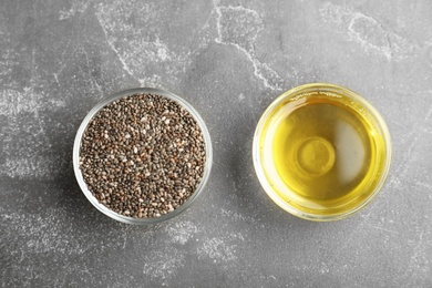 Photo of Flat lay composition with chia seeds and oil on grey table