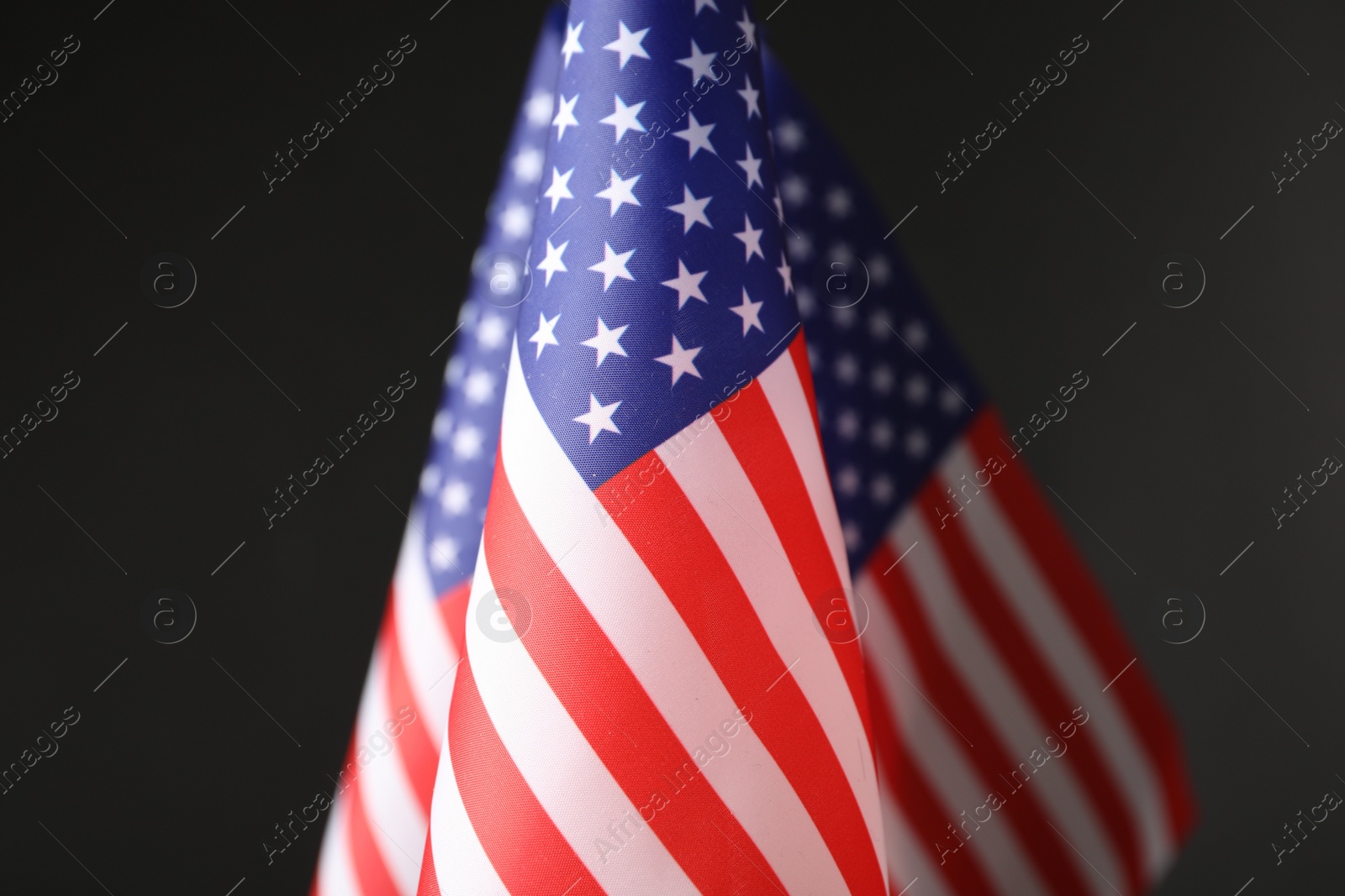 Photo of National flags of America on black background. Memorial day celebration