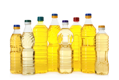 Photo of Cooking oil in different bottles isolated on white