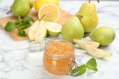 Photo of Delicious pear jam and fresh fruits on white marble table