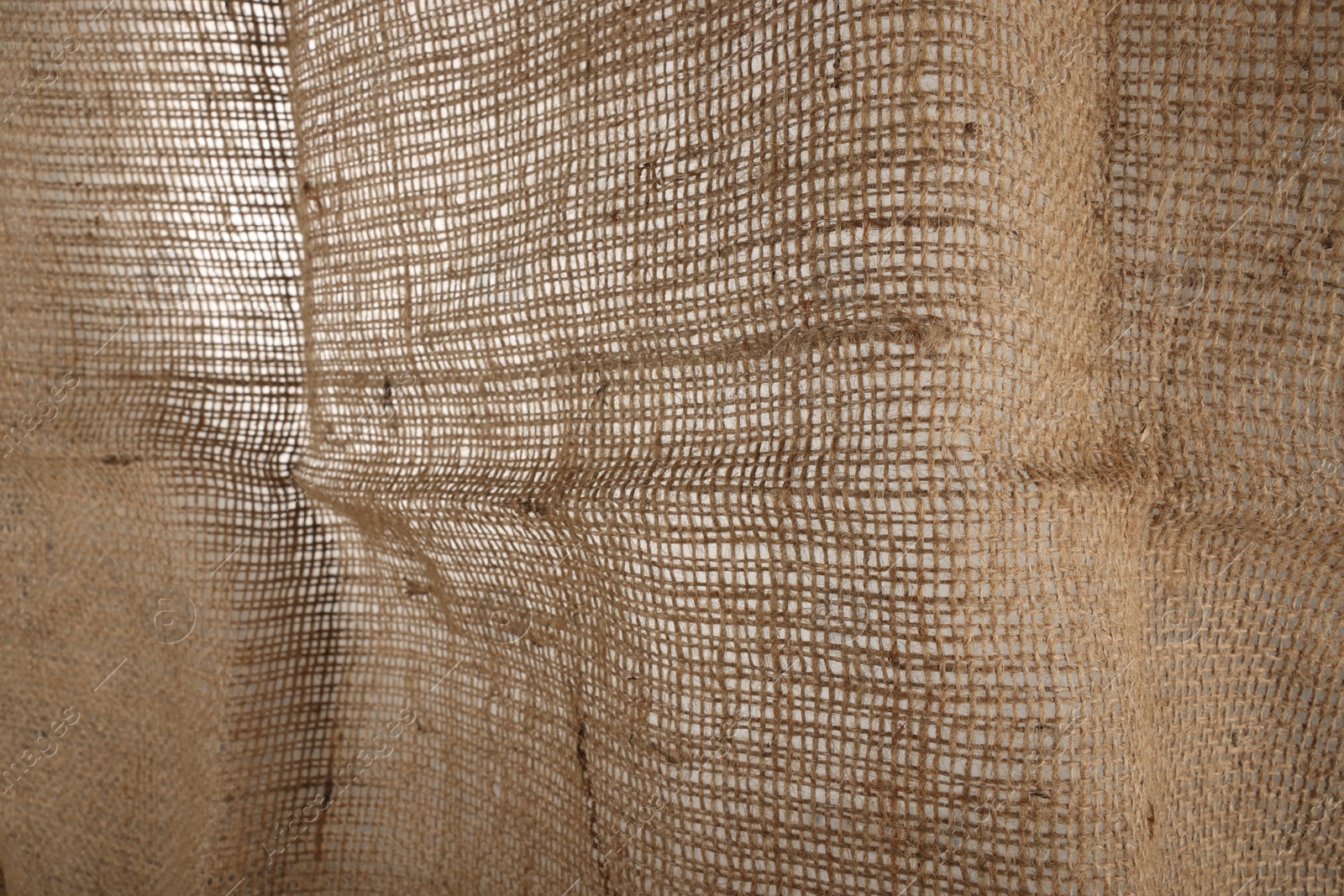 Photo of Texture of natural burlap fabric as background, closeup