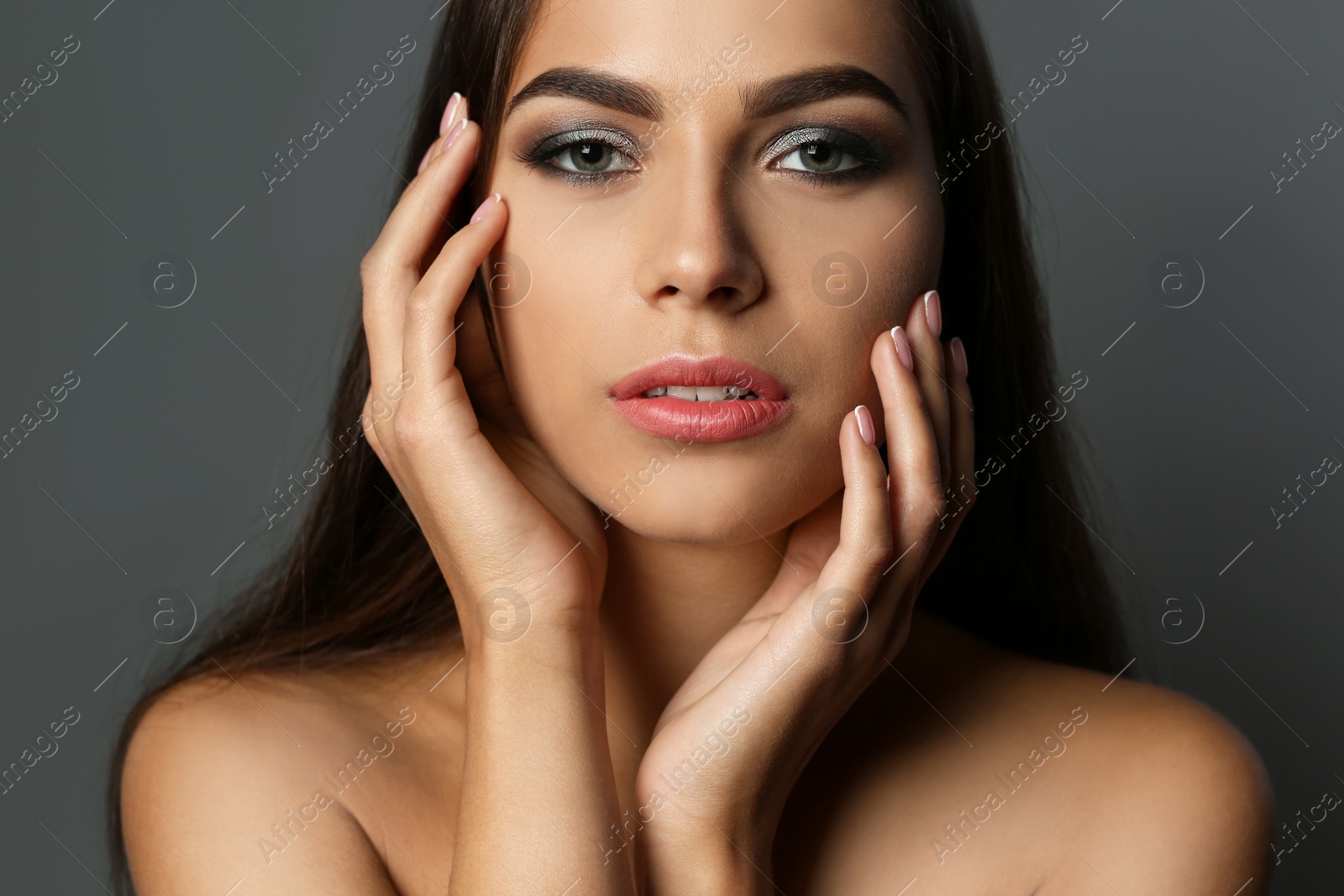 Photo of Portrait of beautiful woman with stylish makeup on gray background
