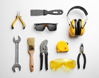 Photo of Flat lay composition with different construction tools on white background