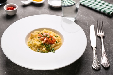 Plate with tasty shrimps and grits on table