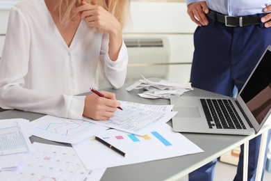 Tax accountants working with documents at table