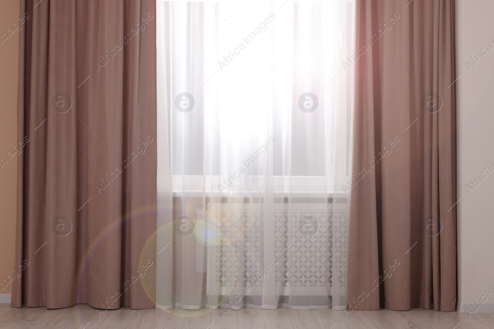 Photo of Window with beautiful curtains in room. Interior design