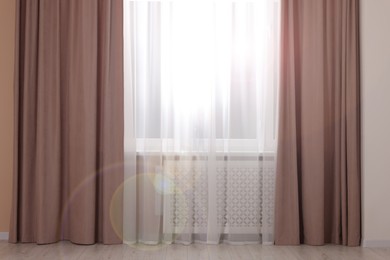 Photo of Window with beautiful curtains in room. Interior design