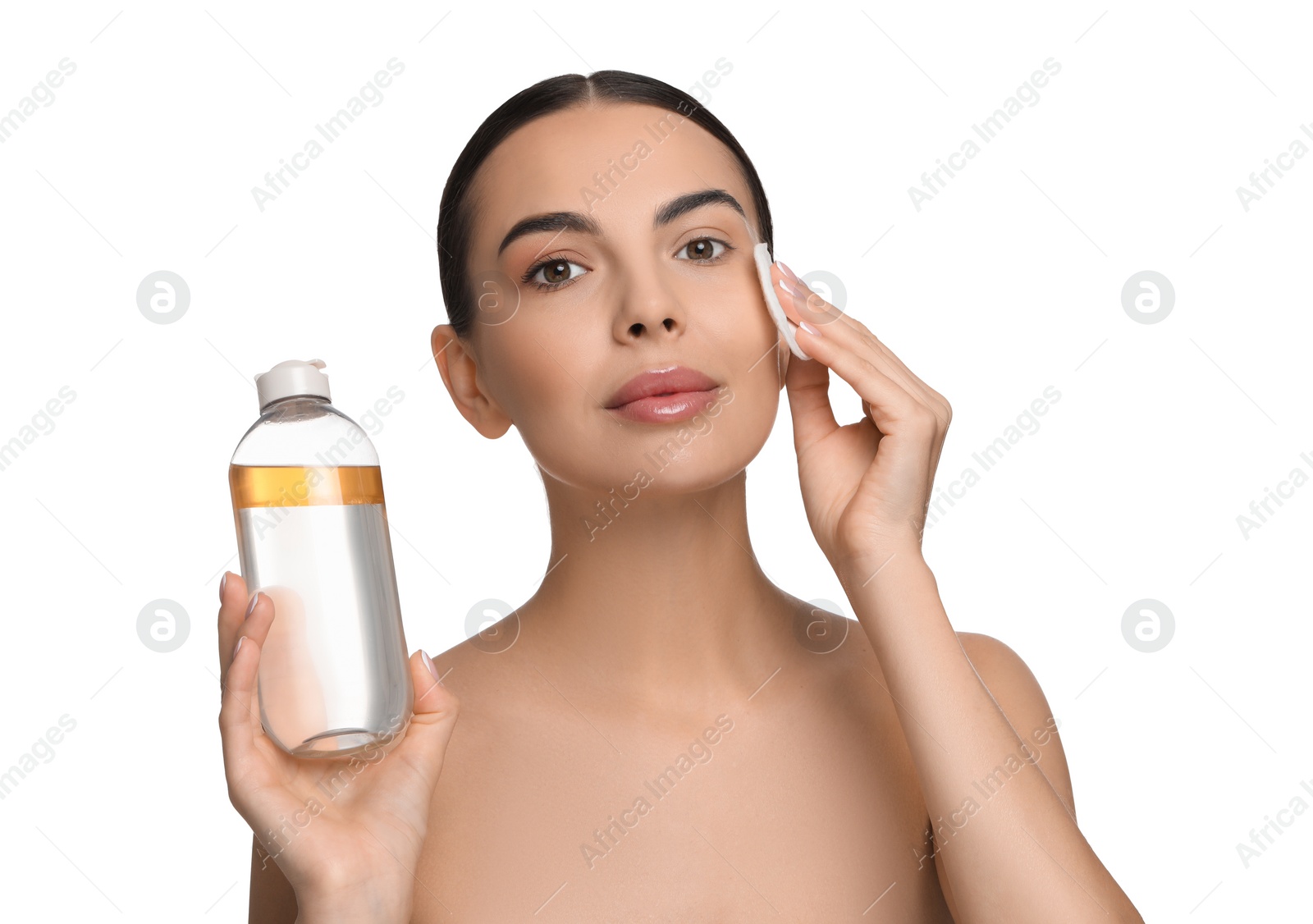 Photo of Beautiful woman removing makeup with cotton pad on white background