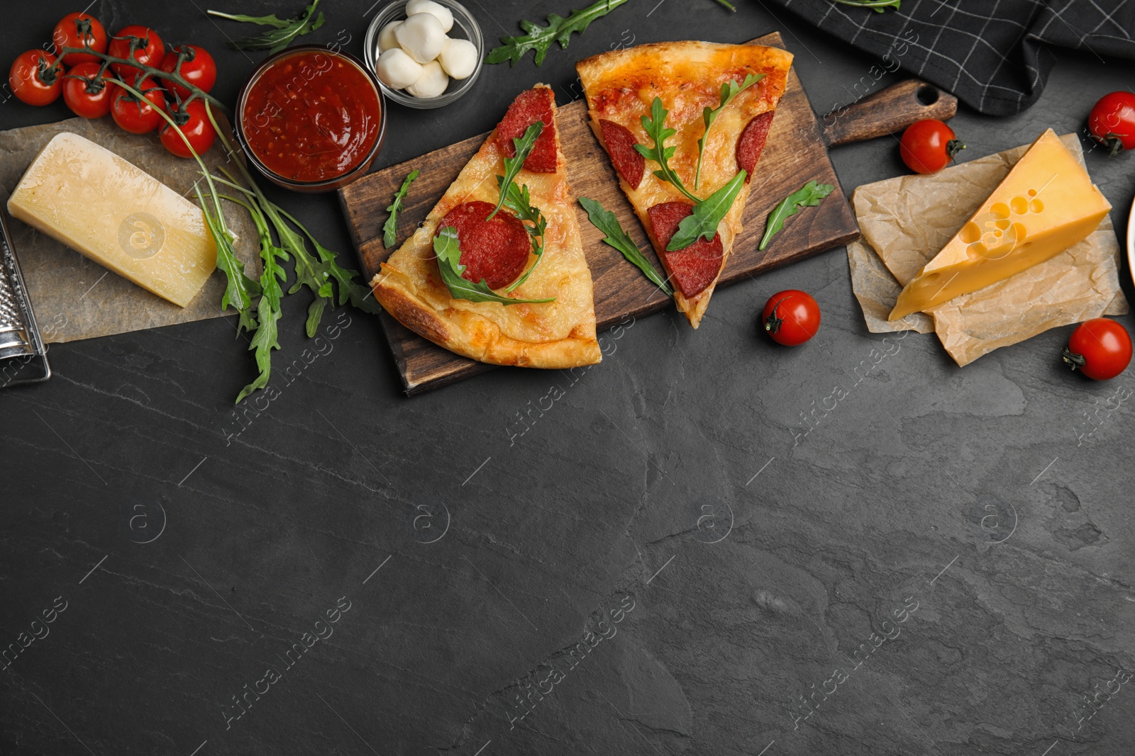 Photo of Flat lay composition with tasty pepperoni pizza on black table. Space for text