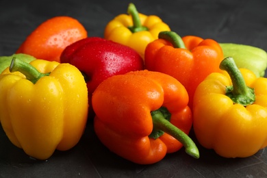 Photo of Wet ripe bell peppers on grey table