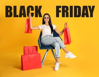 Image of Black Friday Sale. Beautiful young woman with shopping bags sitting in armchair on yellow background