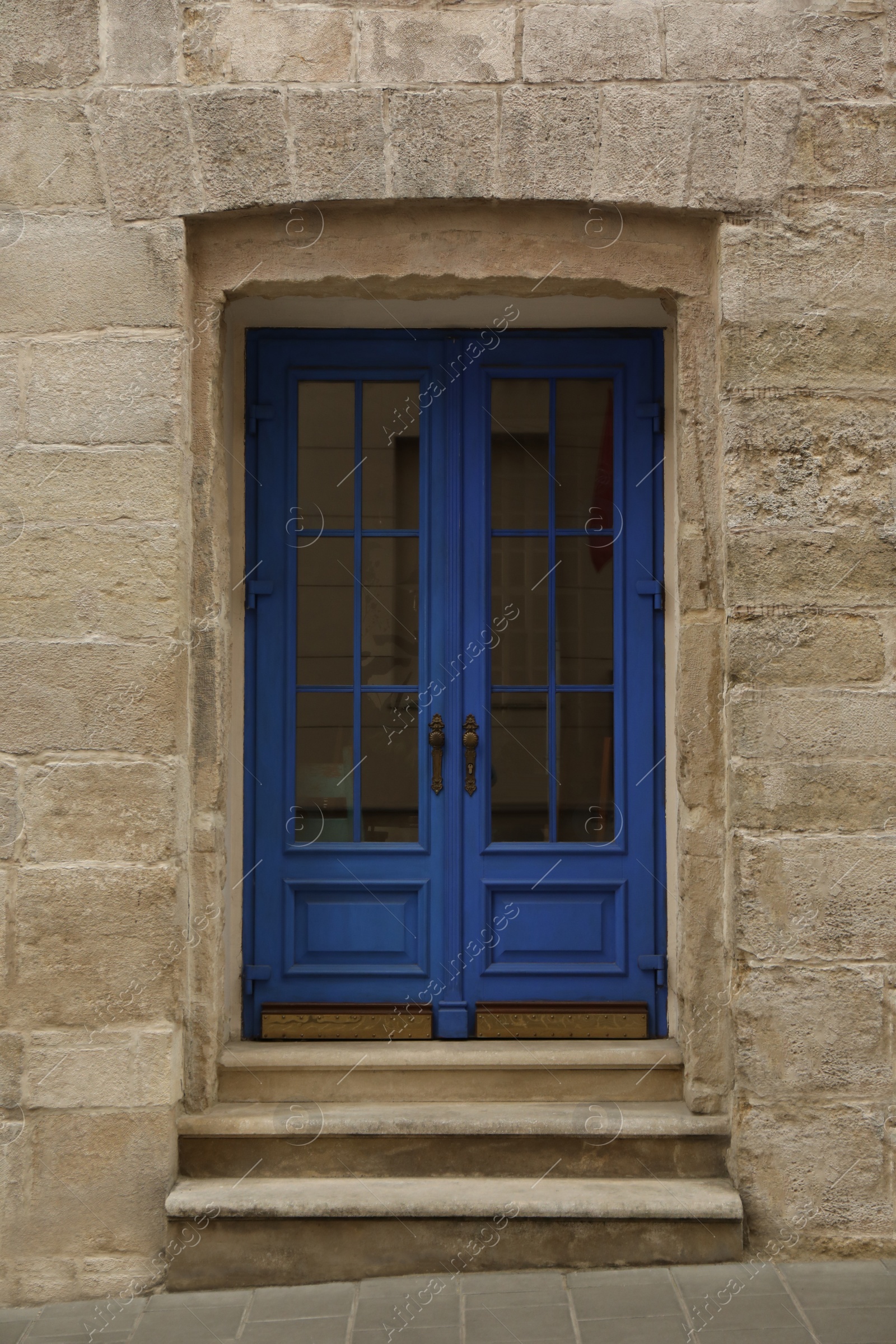 Photo of View of building with blue wooden door. Exterior design