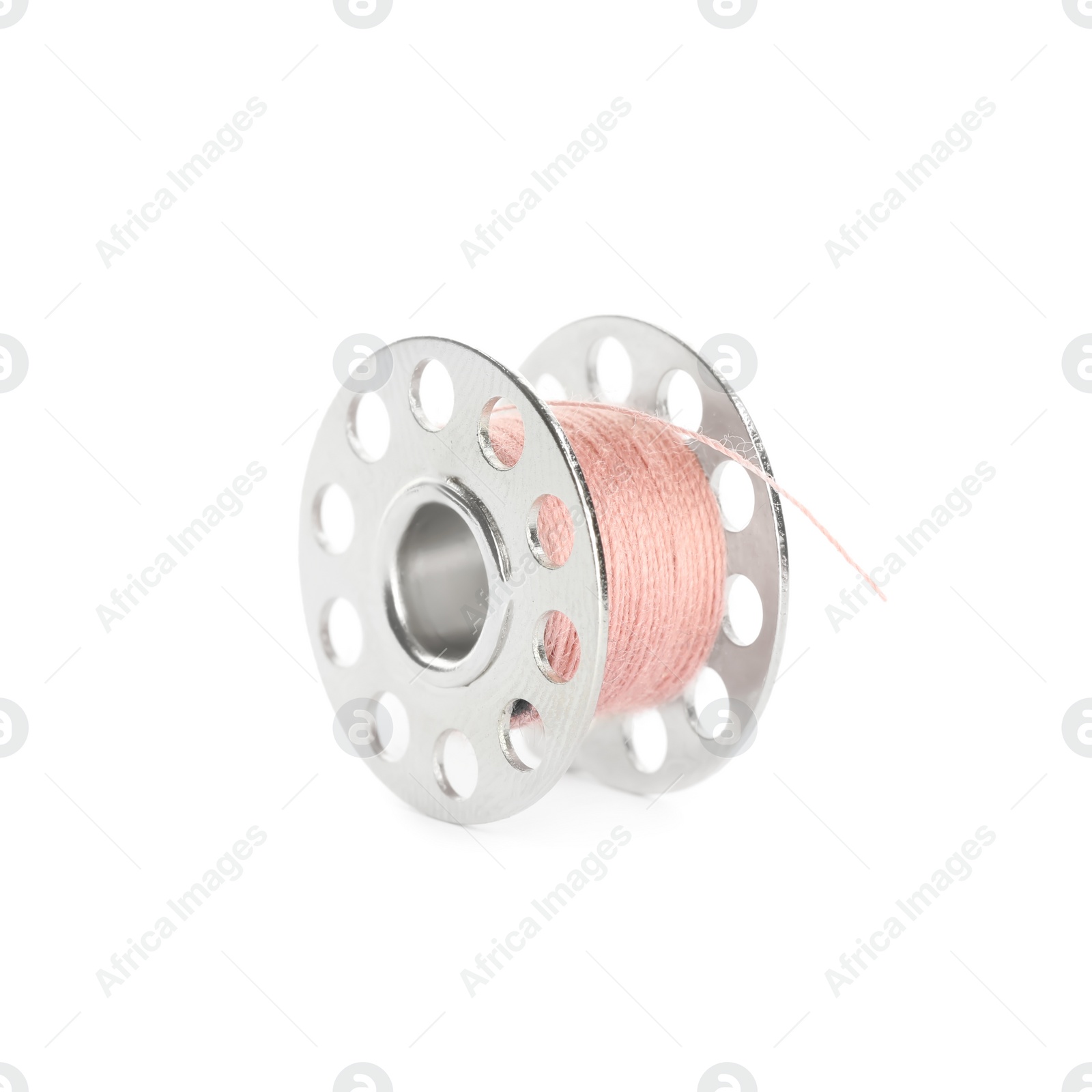 Photo of Metal spool of pink sewing thread isolated on white