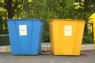 Photo of Recycling bins for different types of garbage outdoors