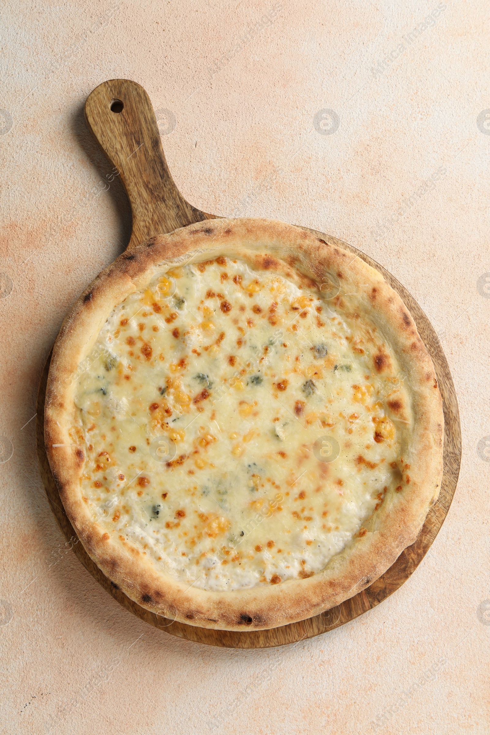 Photo of Delicious cheese pizza on beige textured table, top view