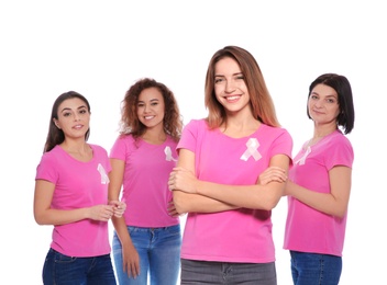 Group of women with silk ribbons on white background. Breast cancer awareness concept
