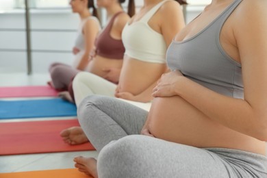 Photo of Group of pregnant women in gym, closeup. Preparation for child birth