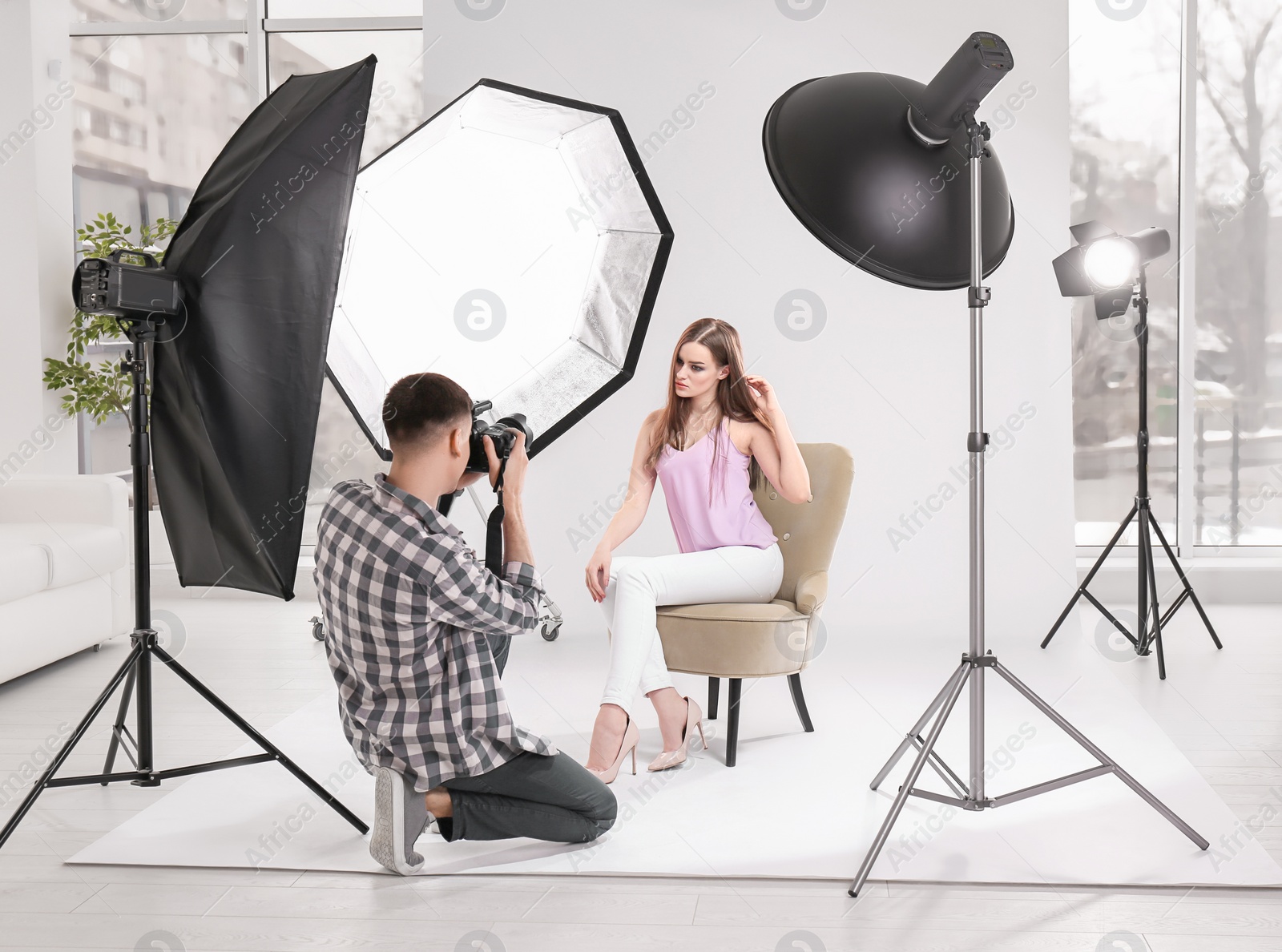 Photo of Beautiful young model posing for professional photographer in studio