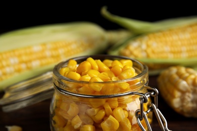 Photo of Tasty sweet corn kernels in jar, closeup view