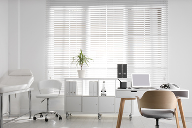 Photo of Doctor's office interior with modern workplace in clinic