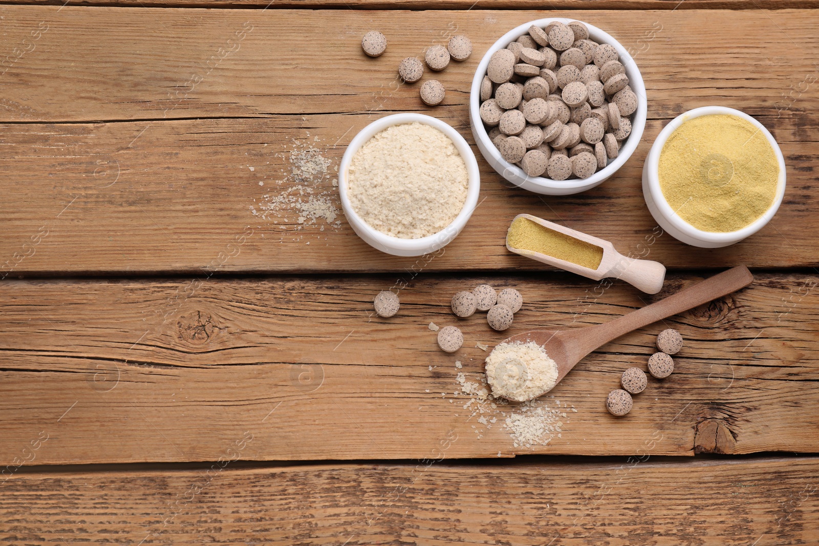 Photo of Flat lay composition with different types of brewer`s yeast on wooden table. Space for text