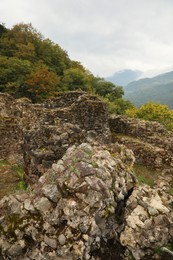 Photo of View on stone ruins and forest in mountains