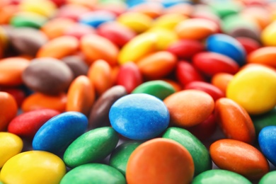 Photo of Many small colorful candies as background, closeup