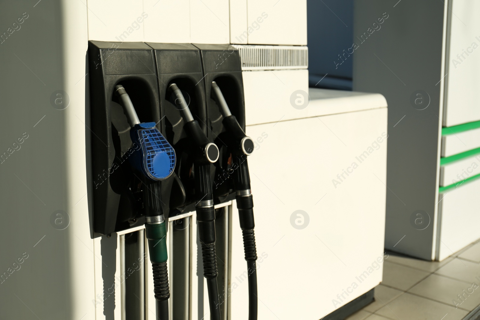 Photo of Petrol pump filling nozzles at gas station