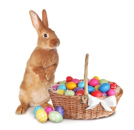 Cute bunny and wicker basket with bright Easter eggs on white background