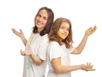 Woman and girl covered with colorful powder dyes on white background. Holi festival celebration