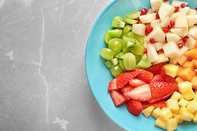 Photo of Plate with fresh cut fruits on table, top view
