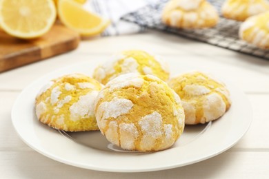 Photo of Tasty homemade lemon cookies on white wooden table